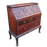 A 19th century Chinese Huanghuali style bureau, the fall flap carved with a pair of dragons and a