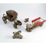 A 19th century wooden model, of a horse drawn carriage, the gilt carriage with printed figures to