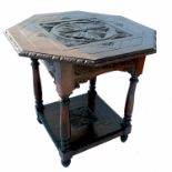 An octagonal shaped oak centre table, with carved central panel and similar shelf below, width