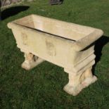 A pair of garden rectangular troughs, moulded with lion masks and scroll ends, raised on lion