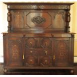 An oak antique style sideboard, the back with fret carved pediment over marquetry inlaid panels,