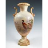 A Grainger’s Worcester blush ivory vase, of urn form, decorated with a cock and hen pheasant in