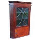 An Edwardian corner cupboard, the glazed cabinet opening to reveal shelves, over a panel, height