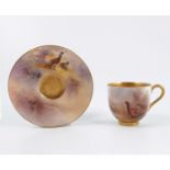 A Royal Worcester miniature cabinet cup and saucer, decorated with pheasants in landscape to the