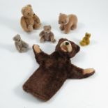 Various small plush bears, one with Steiff button in its ear, another possible Schuco bear, a hand