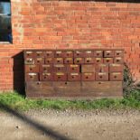 A set of apothecary’s drawers, with named titles, width 83ins