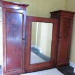 A Victorian mahogany sentry box wardrobe, fitted with a mirror door opening to reveal fitted