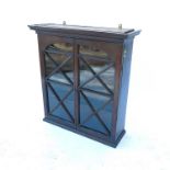 A 19th century oak hanging display cabinet, with two glazed doors opening to reveal shelves, width