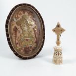 A Victorian reliquary, of oval form, with decoupage decoration of pierced gilt paper cross with an