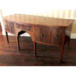 A Georgian mahogany bow front sideboard, fitted with a single drawer flanked by two drawers and