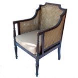 A Regency style bergere armchair, with reeded decoration to the arms and front supportsCondition