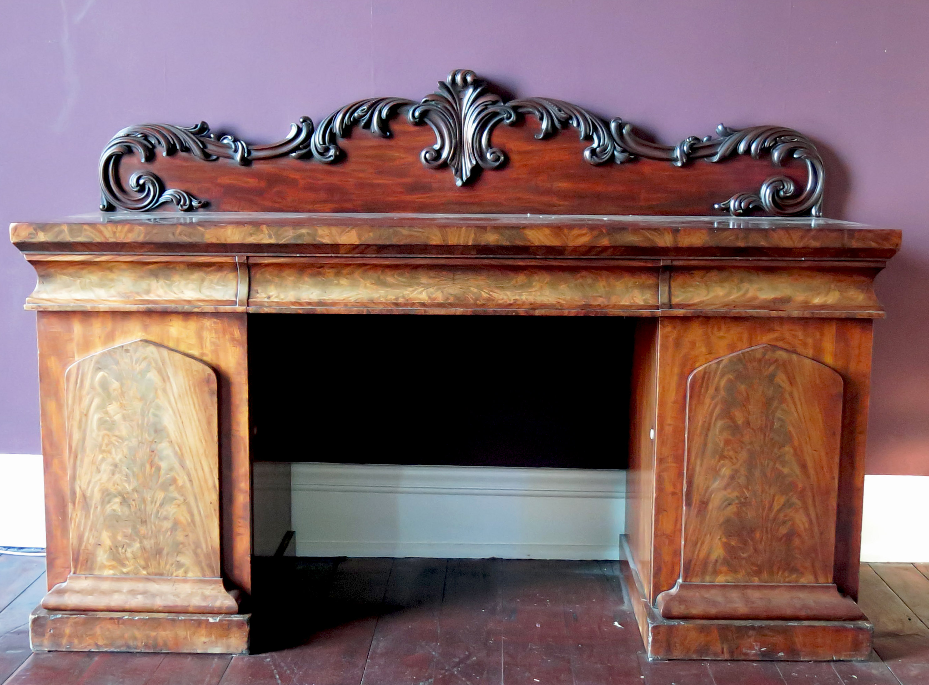 A Victorian mahogany twin pedestal sideboard, with foliate carved supastructure, fitted with a