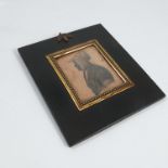 An early 19th century framed portrait silhouette, by Wakins, of a woman wearing a bonnet, with