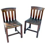 A pair of Arts and Crafts style lathe back single chairs, bearing Rowley labels