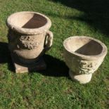 A garden urn, with moulded decoration, a pair of handles and raised on a square pedestal foot,