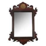 A Georgian design mahogany fret cut wall mirror, decorated with a gilt shell to the scroll top,