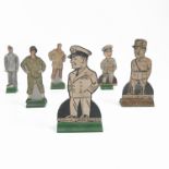 A collection of cut out figures, prints laid on a wooden back with wooden stand, of military