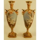 A pair of Royal Worcester vases, one decorated with five swans, the other with four swans, each to a