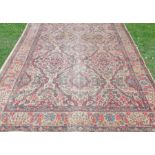 An Eastern rug, decorated with flowers to a cream ground, 72ins x 117ins