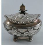 A Victorian silver caddy, of oval form, with carved ivory finial, embossed decoration, gadrooned