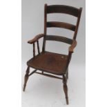 An antique Windsor armchair, having turned spindles to the open arms, with elm seat, raised on