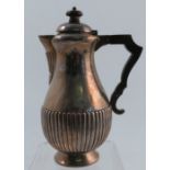 A silver hot water jug, of baluster form with gadrooned lower body and raised on a circular pedestal