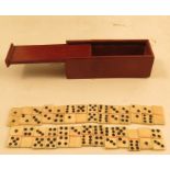 Twenty-seven miniature carved bone dominoes, together with a mahogany box, with slide cover,