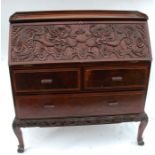 A 19th century Chinese hardwood bureau, having a fall flap carved with two dragons, above two