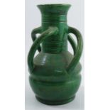 A 20th century Art pottery vase, with four scroll handles and decorated with a green lustre glaze,