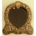 A silver mounted photograph frame, the heart shaped frame pierced with figures, scrolls, leaves