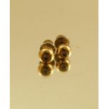 A pair of 18 carat gold single stone diamond ear studs, the brilliant cuts totalling approximately