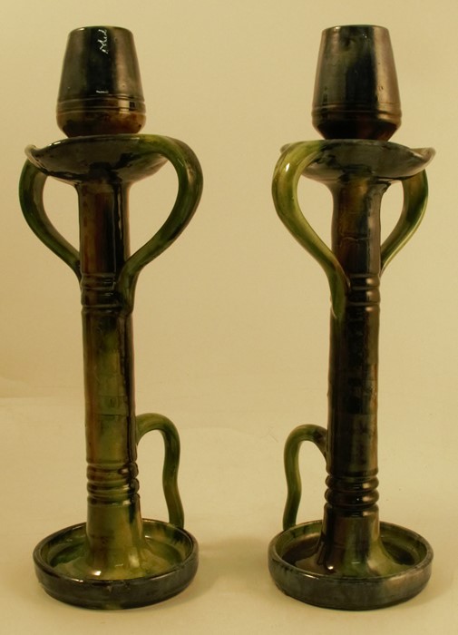 A pair Thulin Belgium pottery chamber sticks, in the style of Christopher Dresser, decorated in