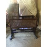 A 19th century mahogany framed and caned child's swinging cradle