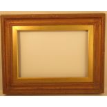 A gilt and composition picture frame, with reeded border an leaves to the corners, overall size