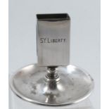 A Walker and Hall silver plated match box holder on a circular base, engraved S.Y Liberty, a steam