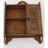 An Arts and Crafts style set of oak hanging shelves, with pierced decoration to the top, having