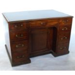 A George III mahogany kneehole partner's desk, with leather writing surface, fitted with an