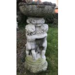 A garden urn, the leaf moulded bowl raised on a column decorated with putti