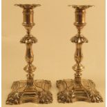 A pair of silver candlestick, with shell decoration the corners of the scones and stepped foot,