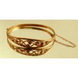 A 9 carat Welsh gold hinged bangle, the open work foliate frontispiece 1.1cm wide, internal diameter