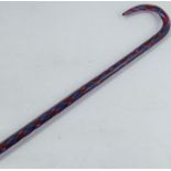 A Victorian glass walking stick, decorated with a red and blue spiral, height 39ins