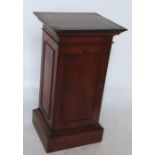 A mahogany pedestal of rectangular form, raised on a plinth base, 16ins x 14.5ins x height 30ins