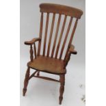 An antique Windsor armchair, with splat back, having turned spindles to the arms, raised on turned