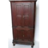 A 19th century oak floor standing corner cupboard, the upper section having a pair of fielded