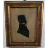 A 19th century framed silhouette portrait, of a man, 4.75ins x 3.75ins