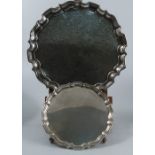 A silver card tray, with shaped ogee border, raised on four knurl feet, with inscription to