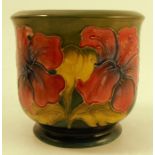 A Moorcroft pottery jardiniere, decorated in the Hibiscus pattern to a green ground, height