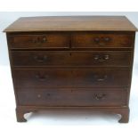 An antique oak chest of drawers, having two short drawers over three long drawers, raised on bracket