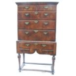 A 19th century walnut chest on stand, fitted with two short drawers over three long graduated