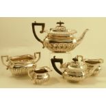 A silver three piece tea set with embossed border and gadrooned lower body, Birmingham 1903,